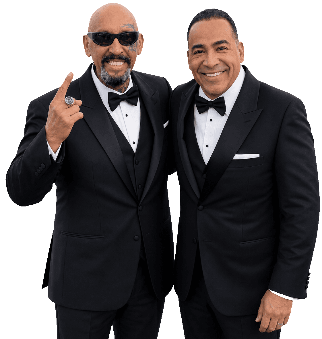 Pastor Phil Aguilar and Tim Storey smiling in black tuxedos